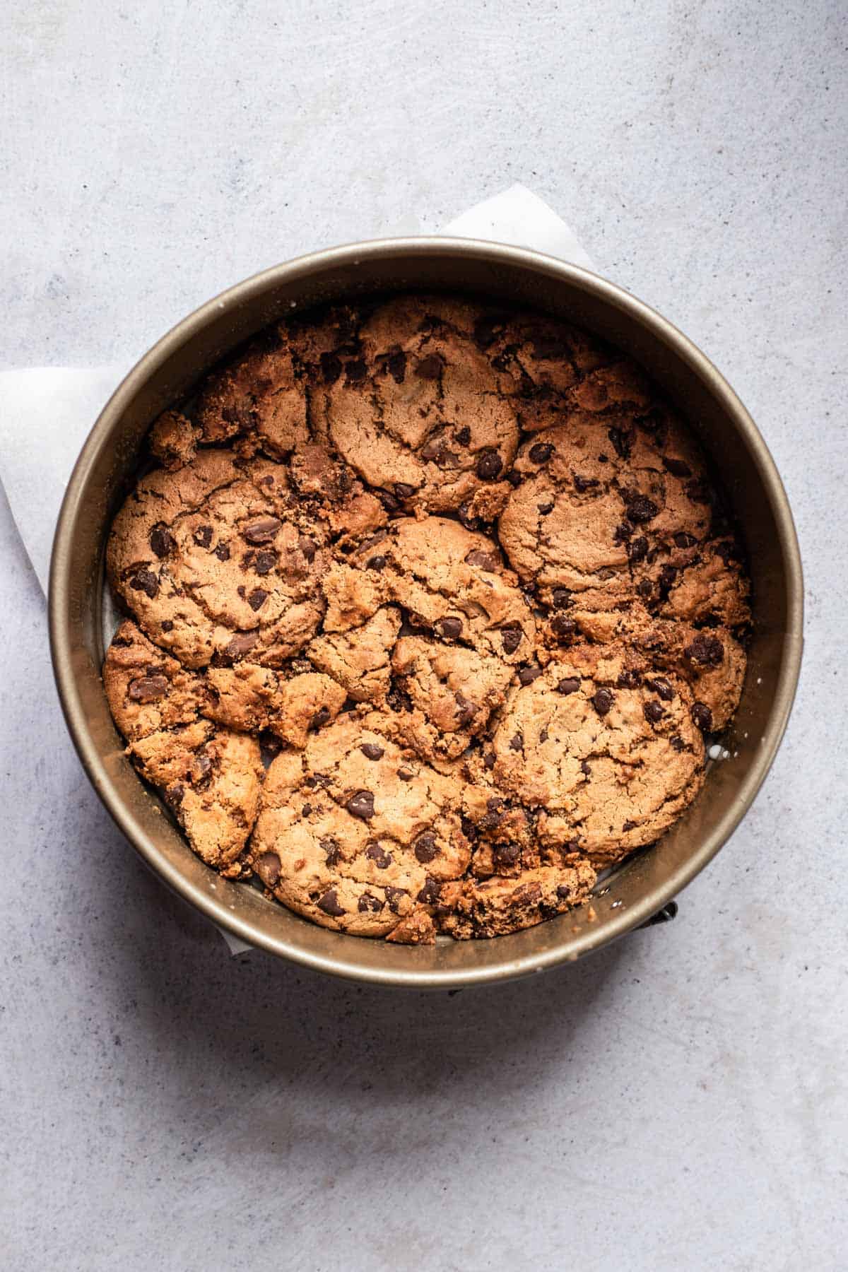 chocolate chip cookies in the bottom of a spring form pan 