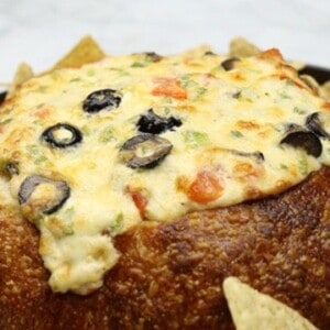 Sourdough Bread Bowl Cheese Dip Recipe on a plate surrounded by tortilla chips
