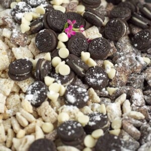close up image of cookies and cream muddy buddies with mini Oreos and white chocolate chips