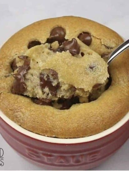 a bite being scooped up from a deep dish s'mores chocolate chip cookie
