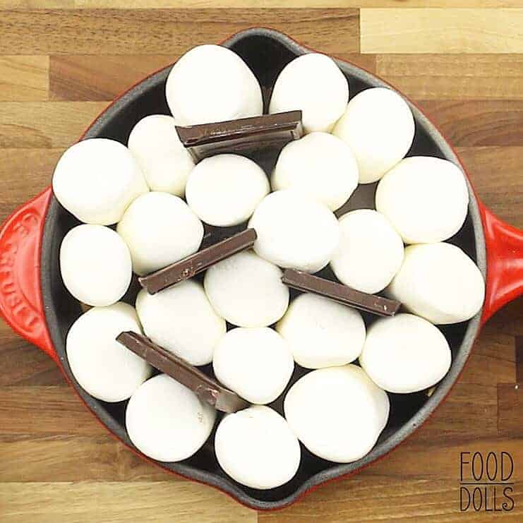 overhead image of a skillet full of marshmallows and chocolate to make peanut butter s'mores dip