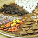 chocolate chip cookie pizza topped with chocolate sauce and candies