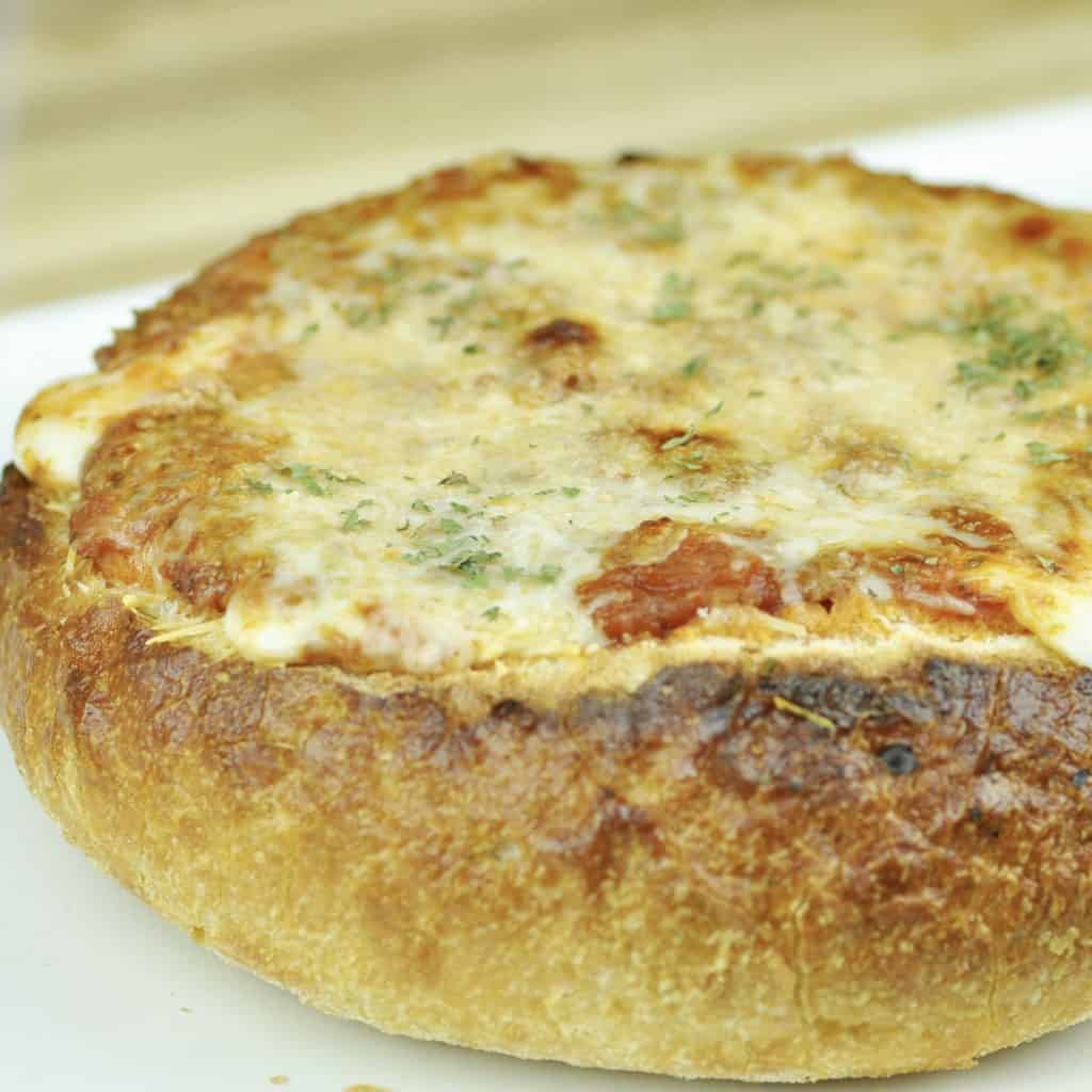 Side view of a baked spaghetti bread bowl.