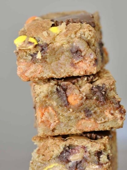 a stack of 3 Reese's peanut butter blondies on top of each other.