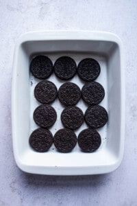 Oreos in a layer in the bottom of a baking dish.