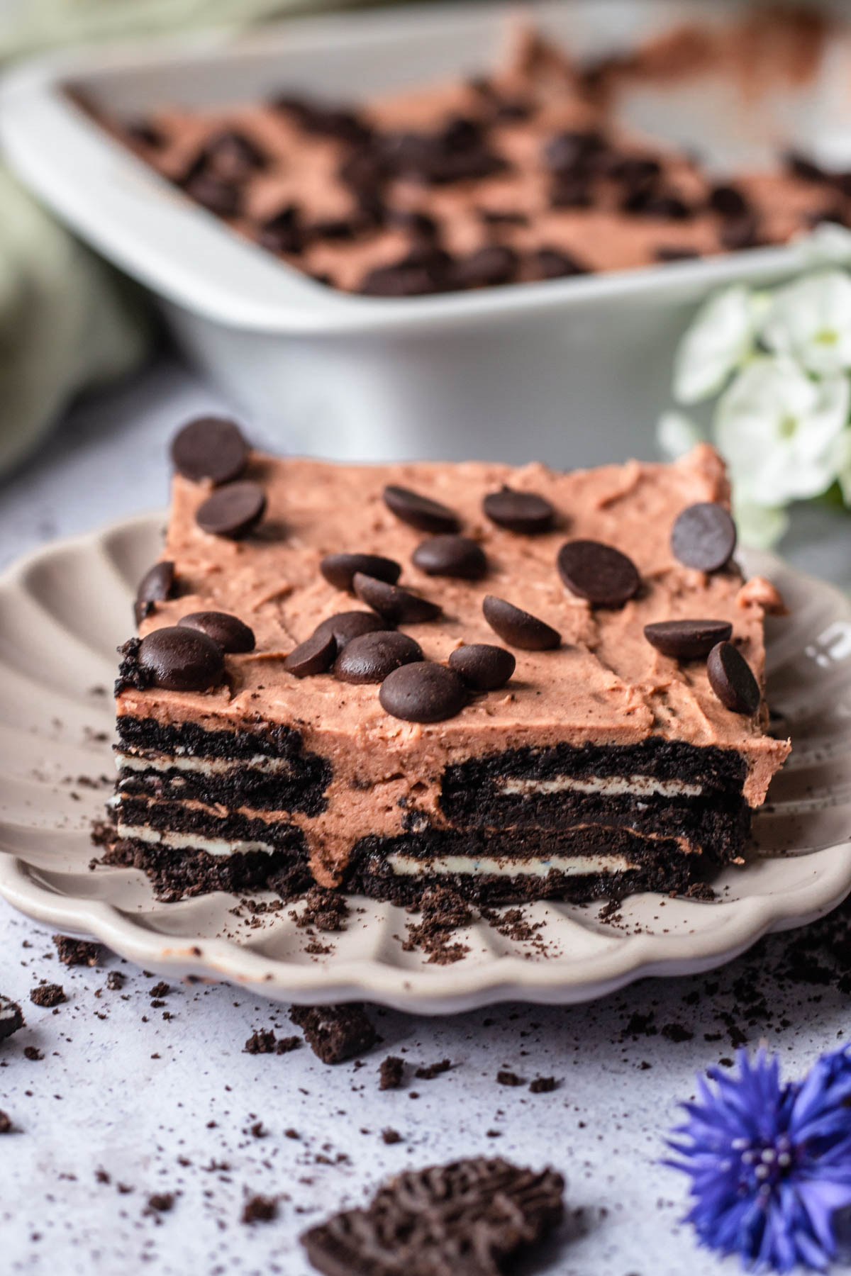 a slice of mocha oreo icebox cake topped with chocolate chips on a white plate