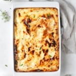 overhead image of baked penne with bechamel sauce in a casserole dish