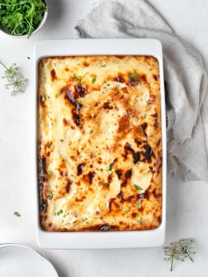 overhead image of baked penne with bechamel sauce in a casserole dish