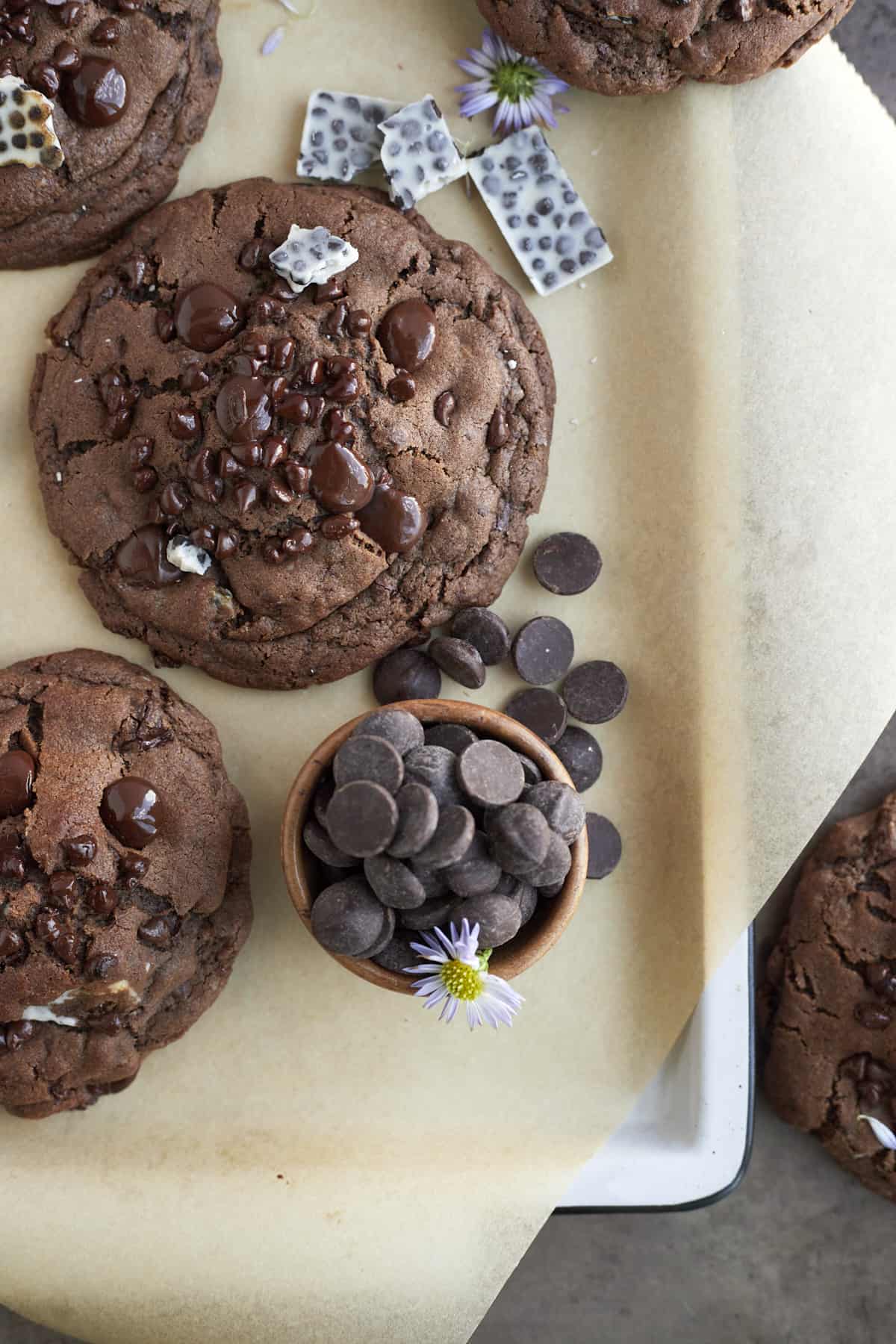 Double chocolate cookies and cream cookies with candy pieces around them. 