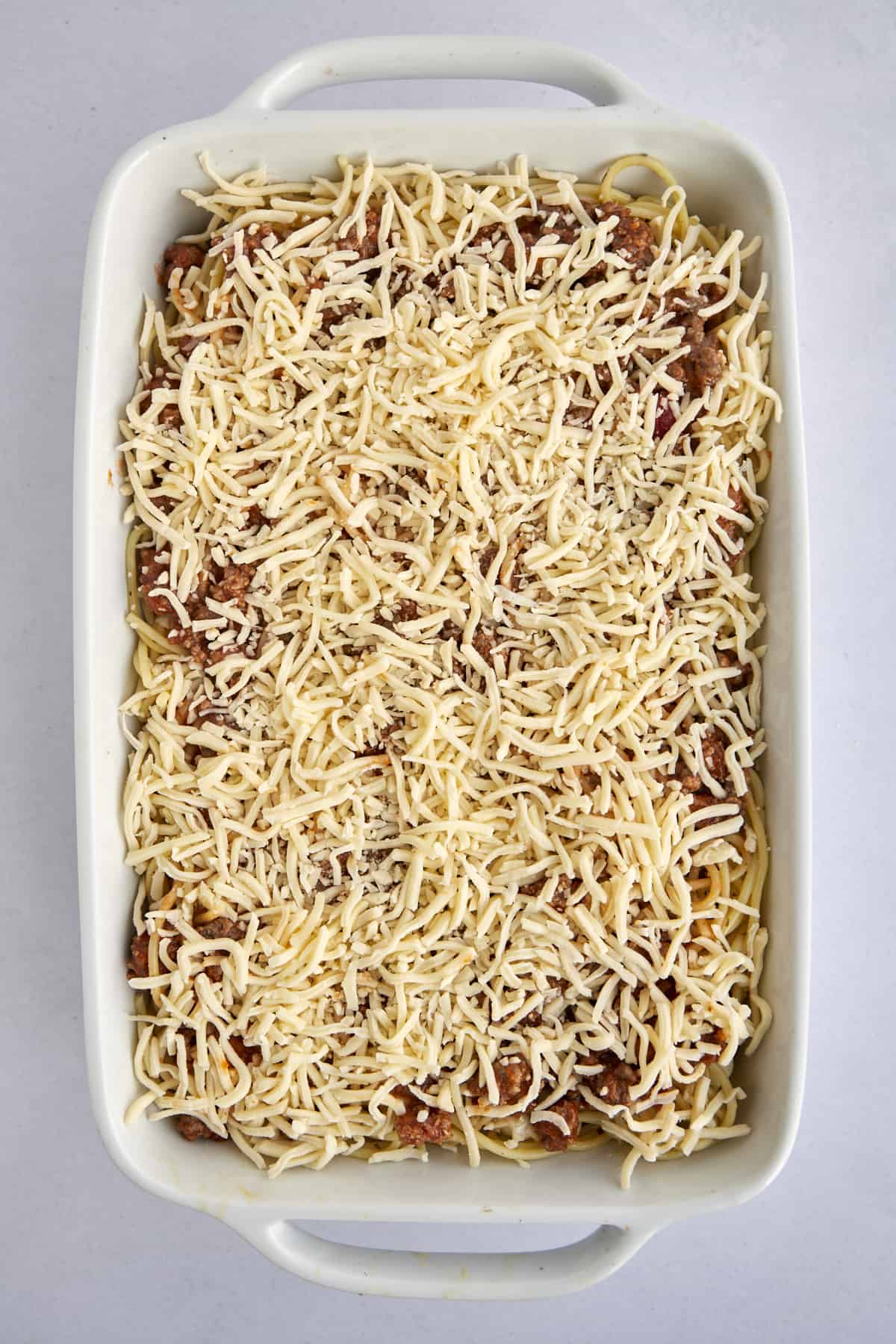 unbaked million dollar spaghetti casserole in a baking dish.