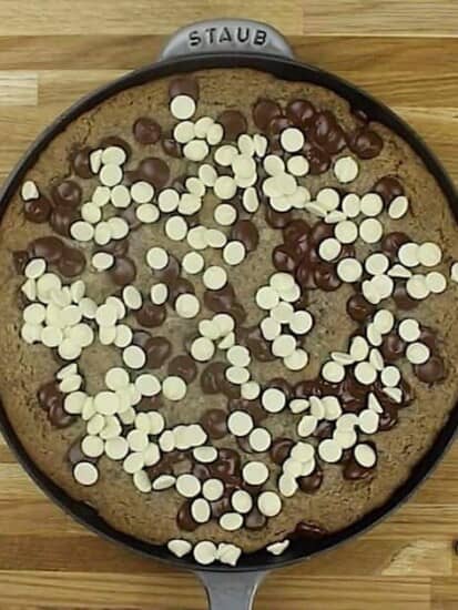 Overhead image of a cookies 'n cream cookie skillet topped with dark and white chocolate chips.