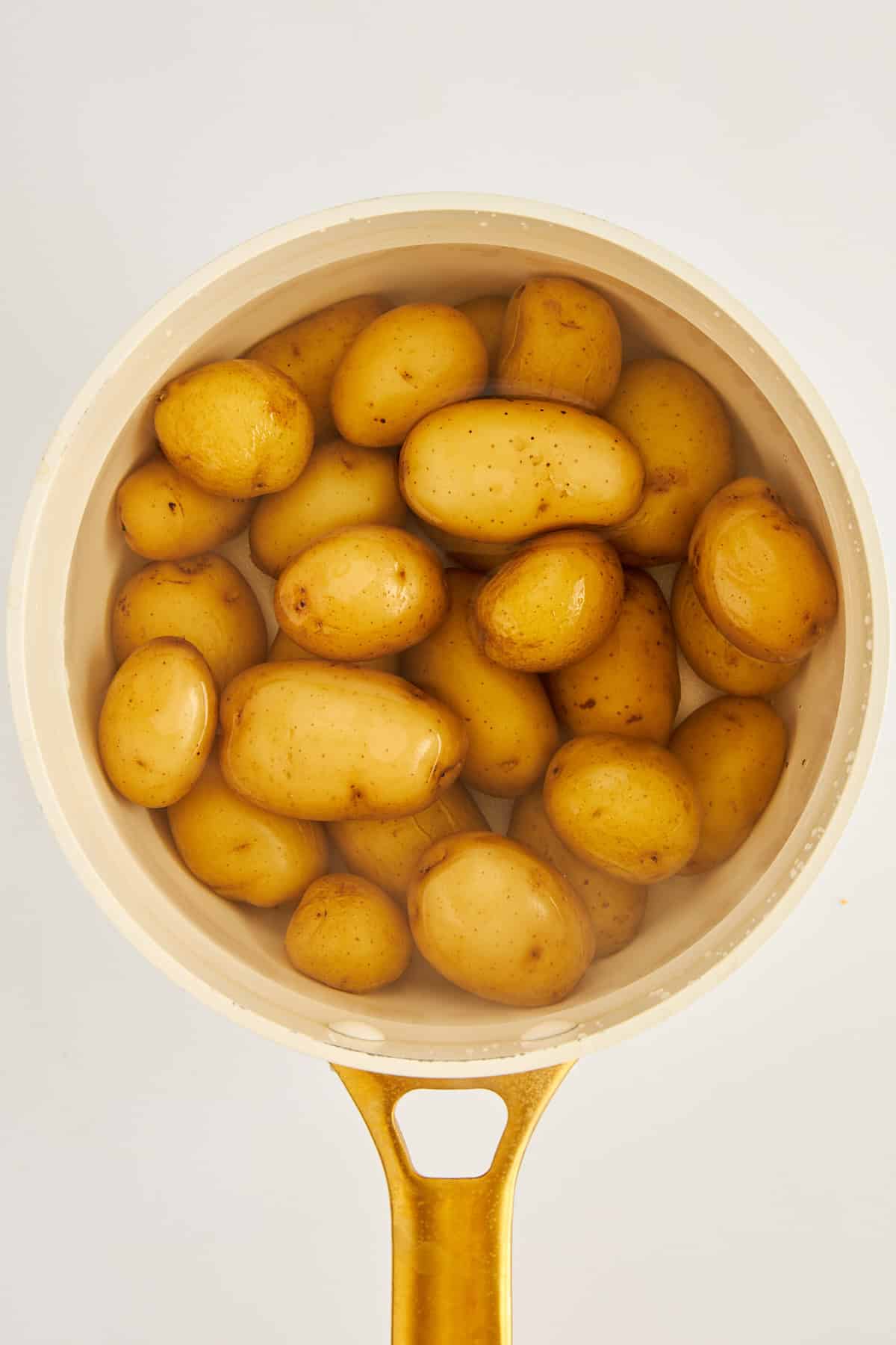Whole potatoes in a pot.