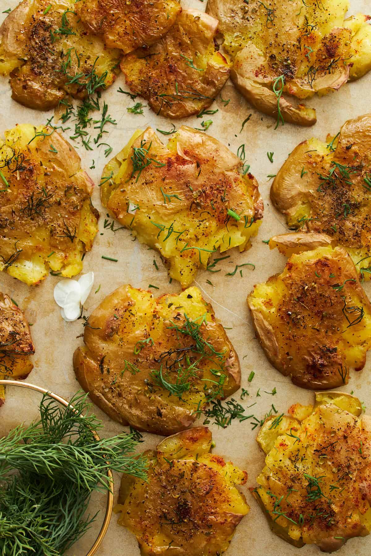 Crispy smashed potatoes on a baking sheet.