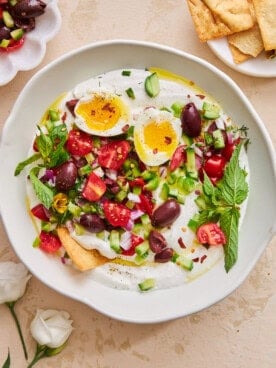 A bowl of whipped cottage cheese salad topped with a runny egg.
