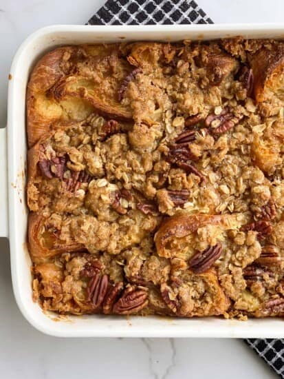overhead image of pecan pie croissant bread pudding in a white baking dish.