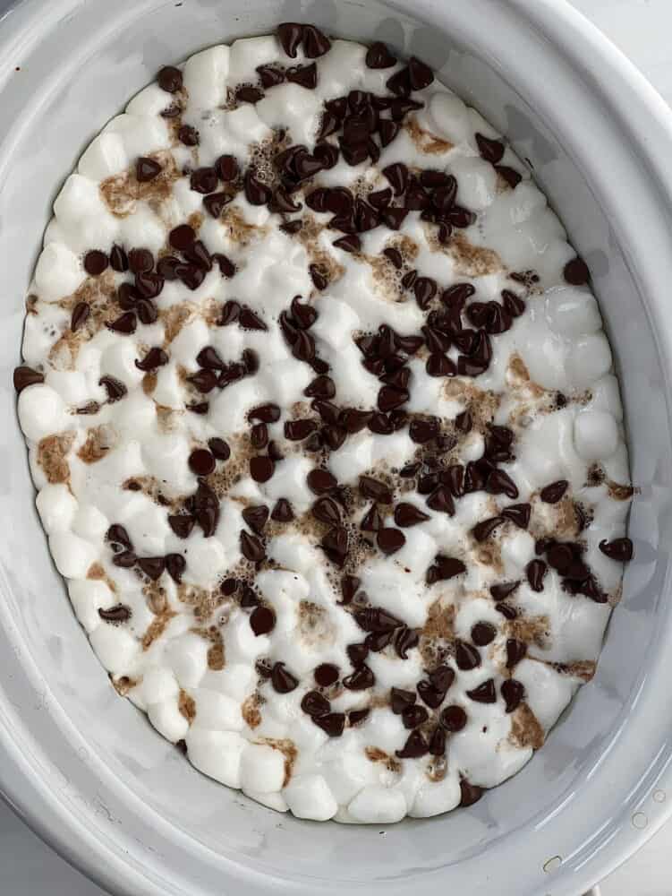 overhead image of slow cooker chocolate smores cake topped with marshmallows and chocolate chips