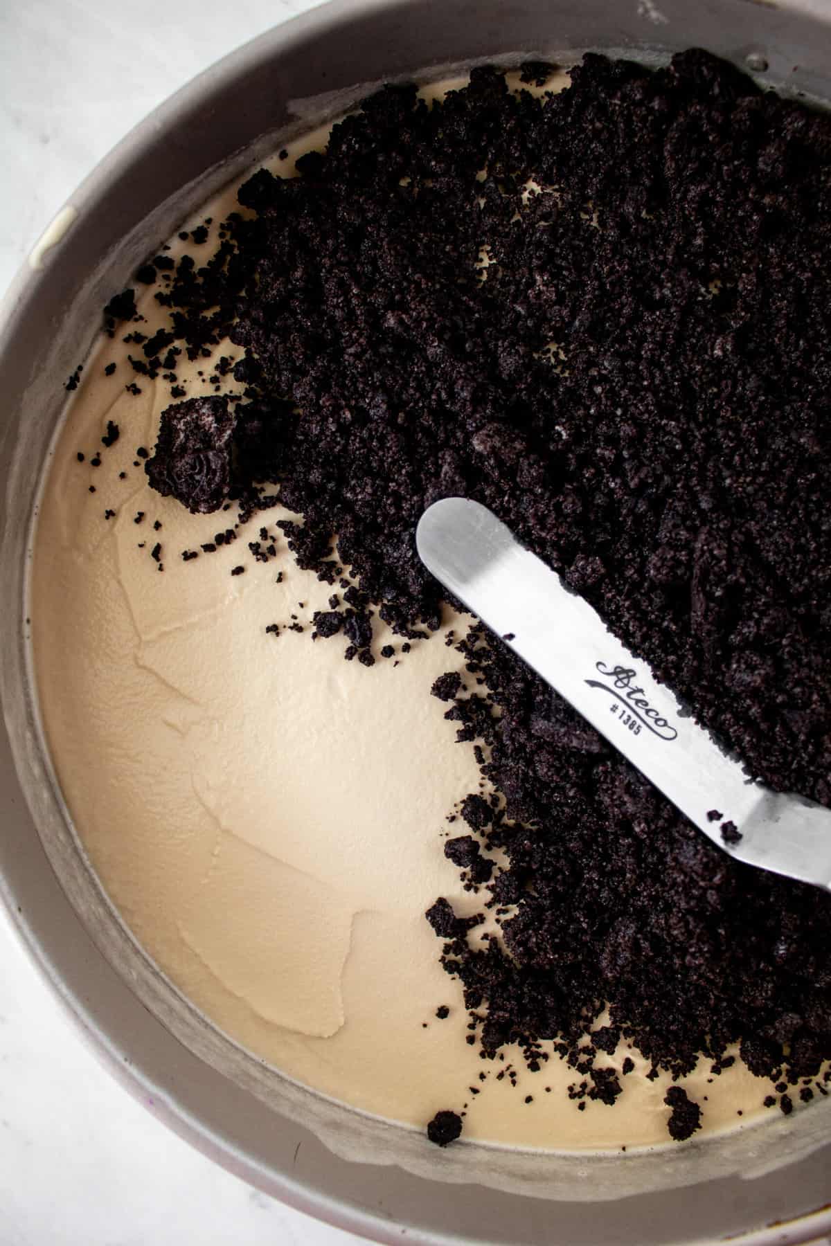 chocolate crust being smoothed over coffee ice cream