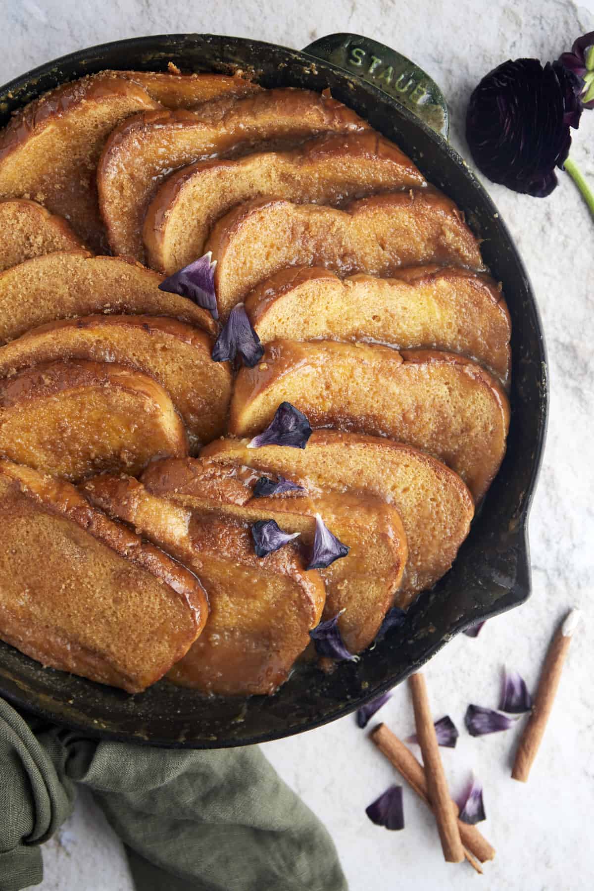 a skillet of french toast topped with caramel sauce