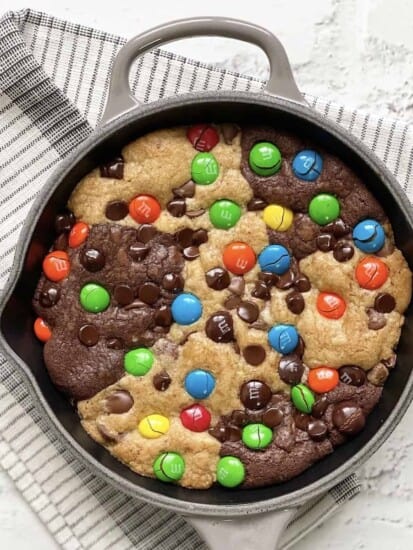 Overhead image of a skillet brookie topped with M&Ms.