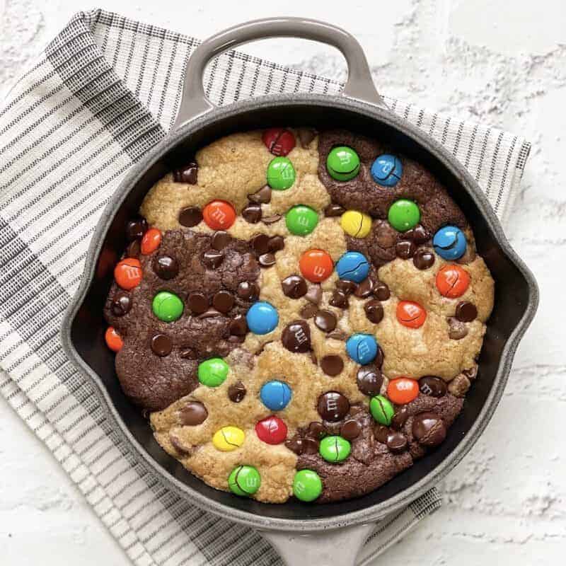 Overhead image of a skillet brookie topped with M&Ms.