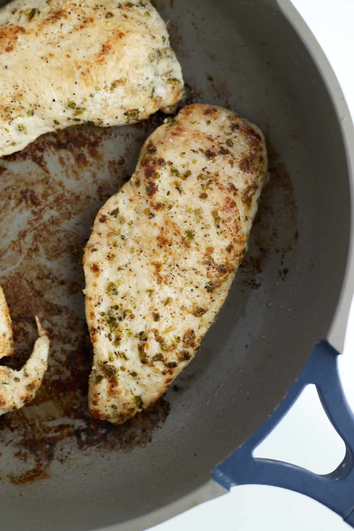 cooked chicken breasts in a skillet.