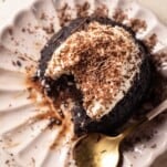 overhead image of a hazelnut chocolate lava cake on a plate with a bite missing and a spoon on the side