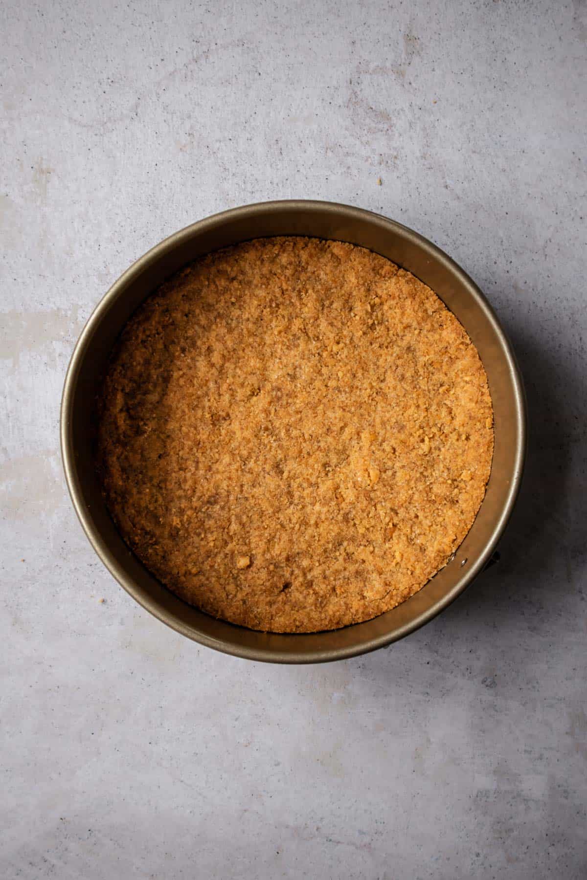 Graham cracker crust in the bottom of a cake pan