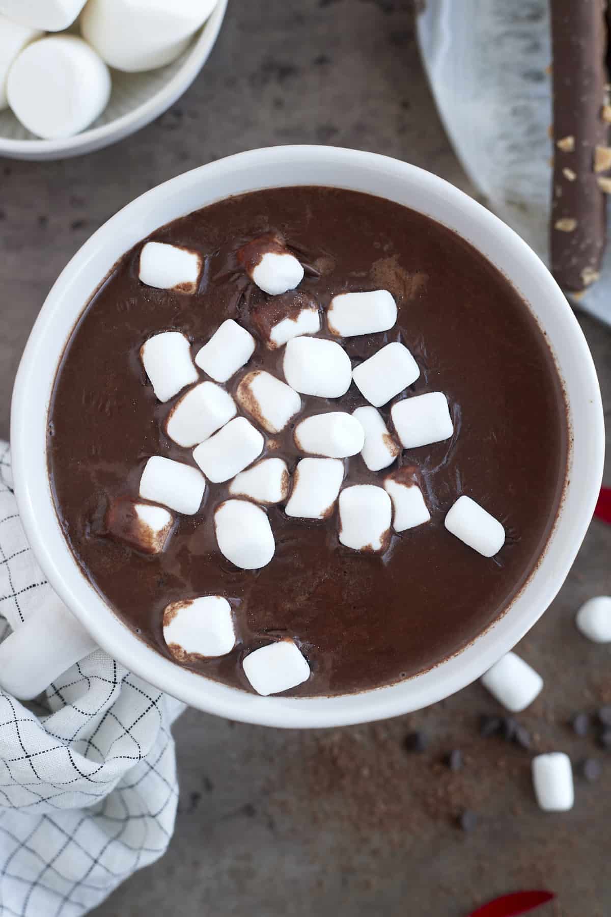 a white mug of espresso slow cooker hot chocolate topped with marshmallows