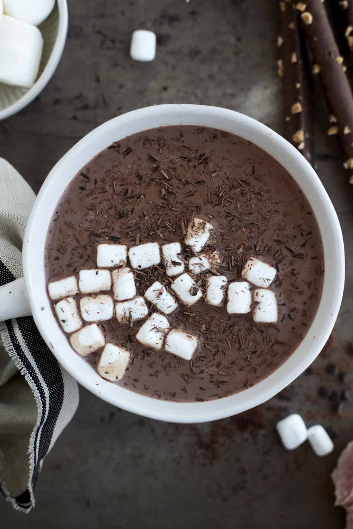 a mug of espresso slow cooker hot chocolate topped with marshmallows and chocolate shavings