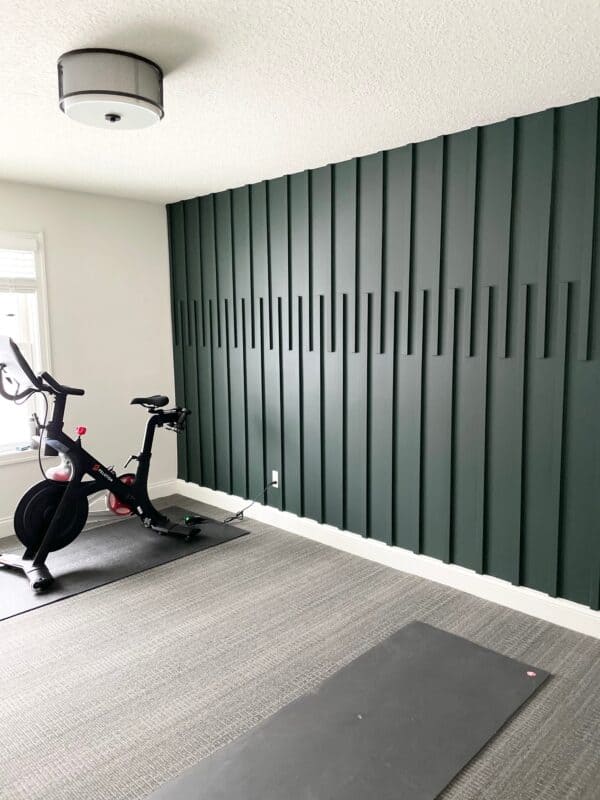 a green accent wall with wood planks