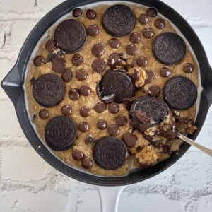 milk and cookies baked oats topped with Oreos and chocolate chips