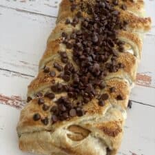 A s'mores braided pastry topped with mini chocolate chips and graham cracker crumbs.