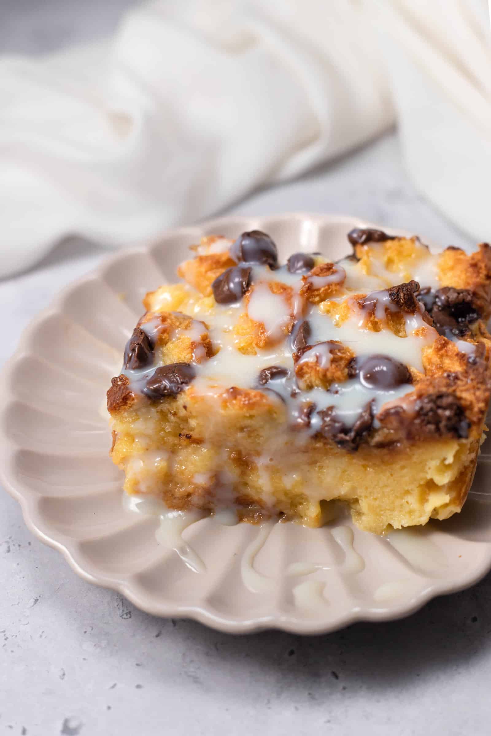 a slice of tres leches bread pudding on a white plate