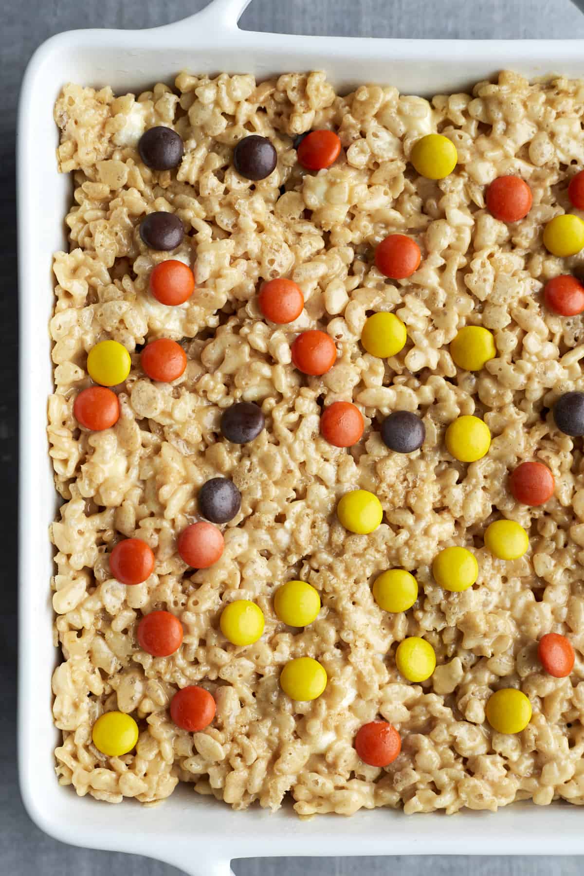 overhead image of Peanut Butter Rice Krispie Treats in a white baking dish.