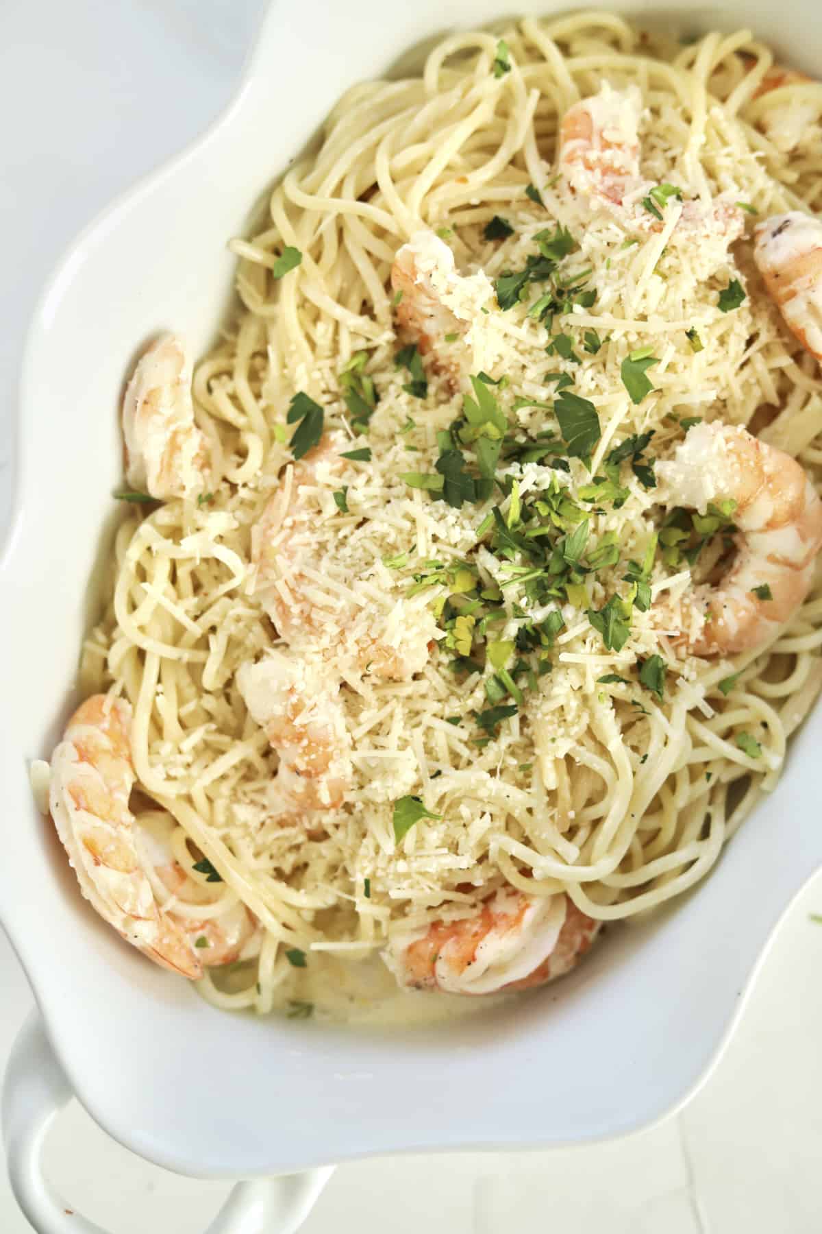 overhead garlic shrimp scampi in a baking dish with fresh parsley