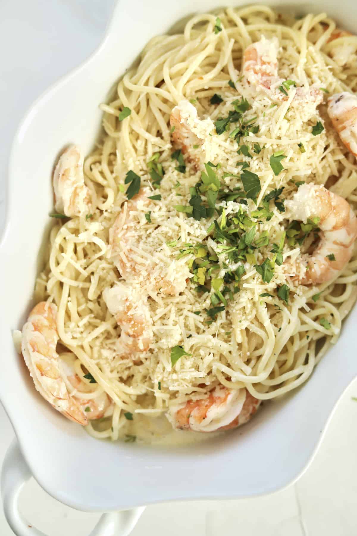 overhead garlic shrimp scampi in a baking dish with fresh parsley