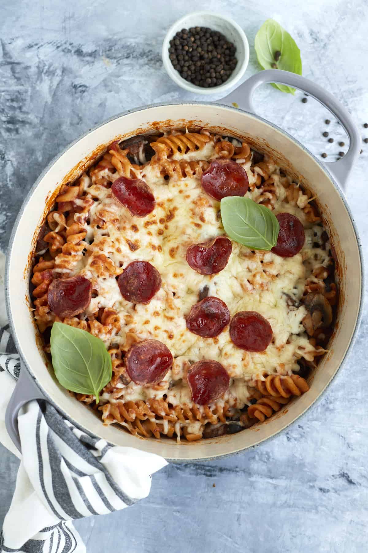 overhead image of cooked pizza pasta topped with melted broiled cheese and pepperonis