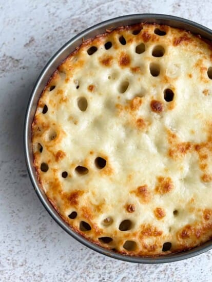 Overhead image of a honeycomb pasta cake in a circular dish.