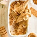 A dish of no-churn Biscoff ice cream with ice cream cones on top.
