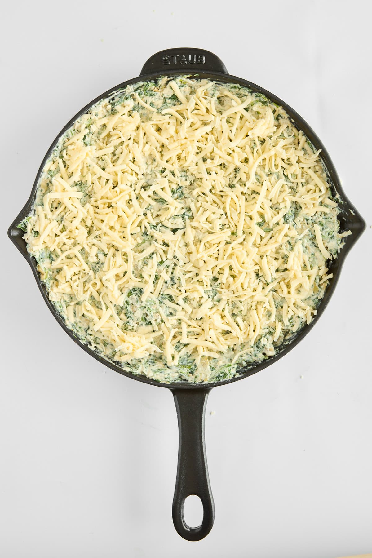 Unbaked chicken spinach and artichoke dip.