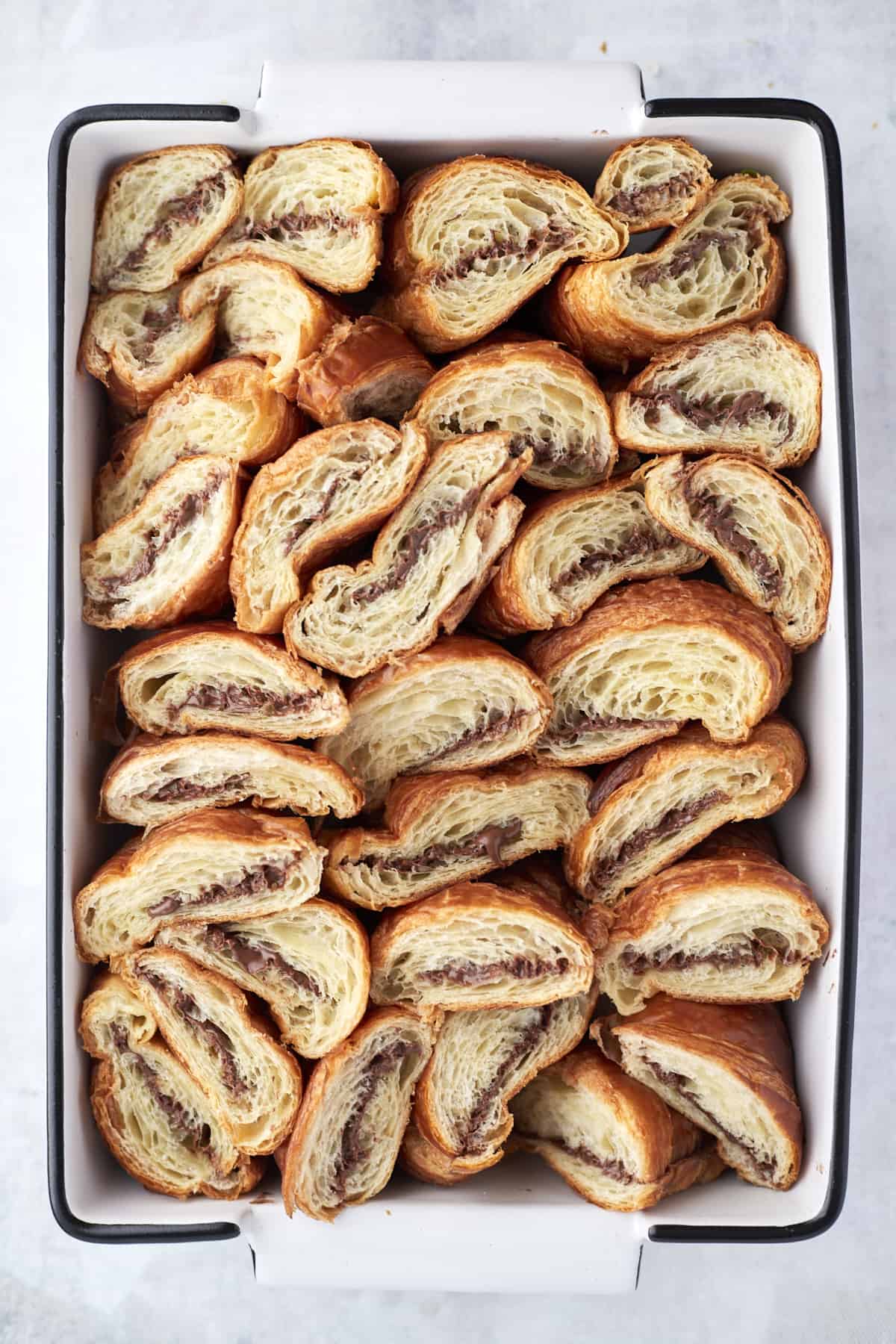 overhead image of Nutella stuffed croissants in a rectangular baking dish