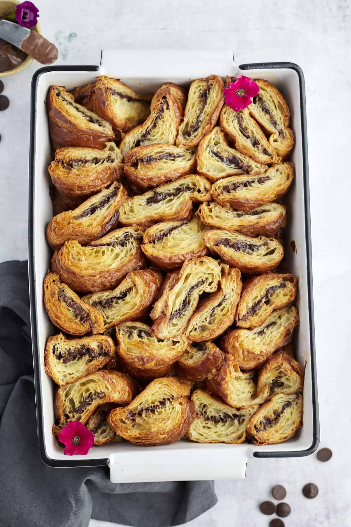 a baking pan full of baked Nutella stuffed croissant french toast