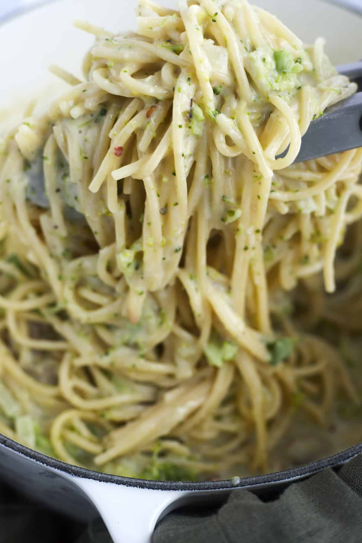 tongs grabbing a helping of one pot pasta primavera