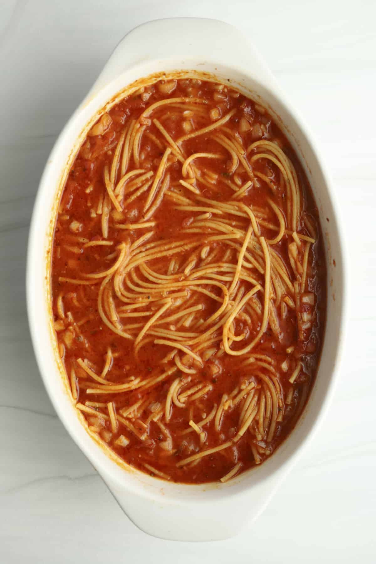 overhead of spaghetti in a baking dish before baking
