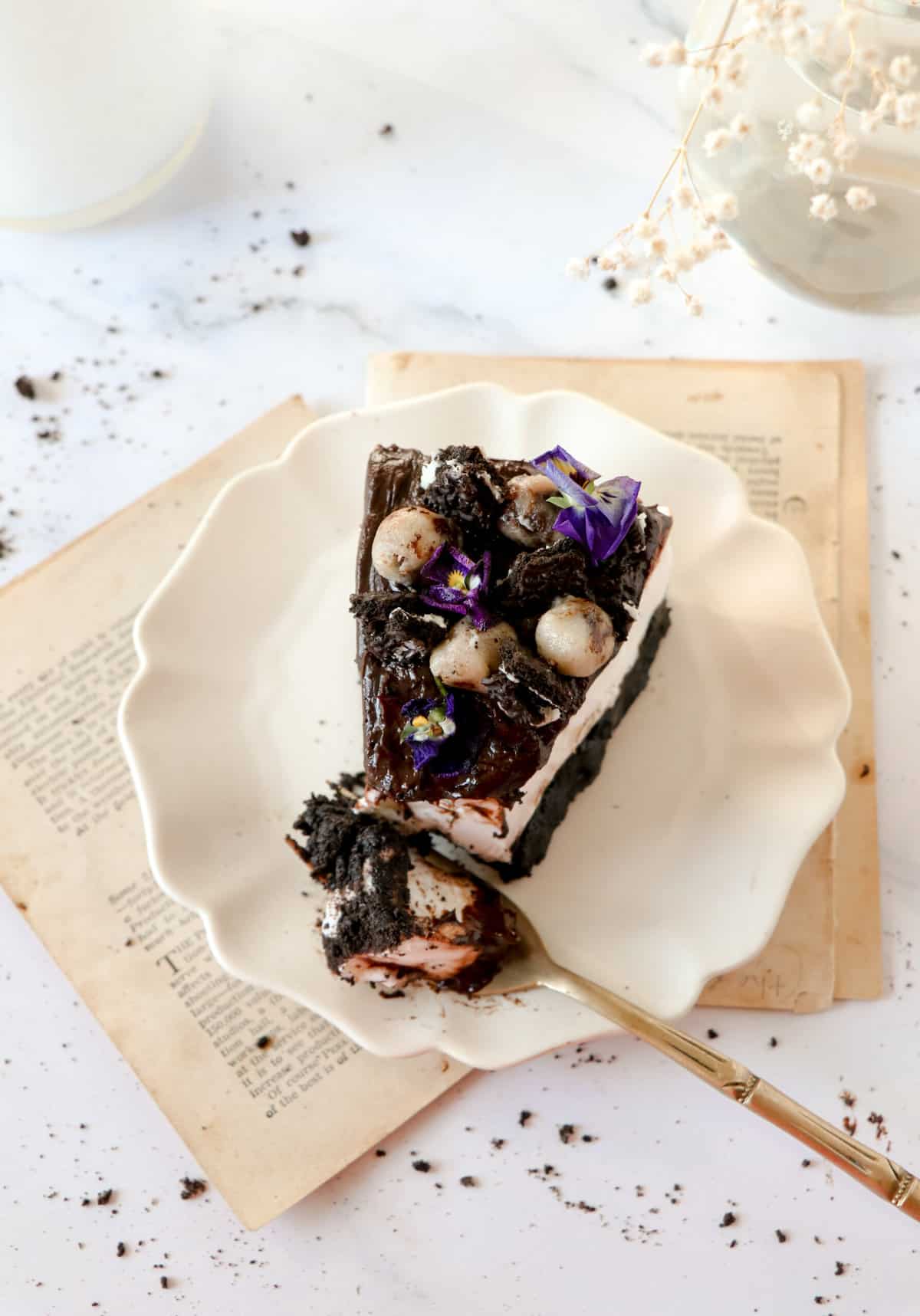 a slice of billy miner cookie ice cream pie on a plate with a fork holding a bite.