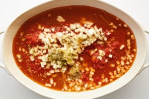 Ingredients for oven baked spaghetti in an oval baking dish.