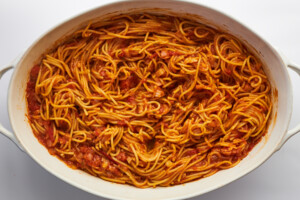 Baked spaghetti in an oval baking dish.
