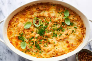 Oven baked spaghetti topped with cheese.
