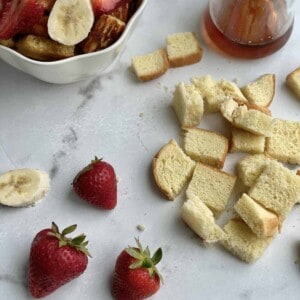 Bread pieces and strawberries to make mini French toast cereal.