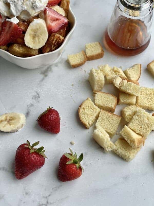 Bread pieces and strawberries to make mini French toast cereal.